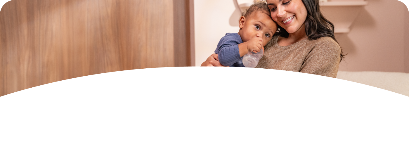 [Translate to French (Reborn):] Mother and Baby with Learner Bottle
