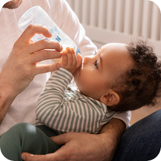 [Translate to French (Reborn):] Father and Baby with Baby bottle
