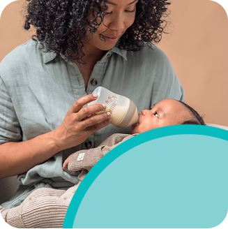 [Translate to French (Reborn):] Mother with Baby and baby bottle